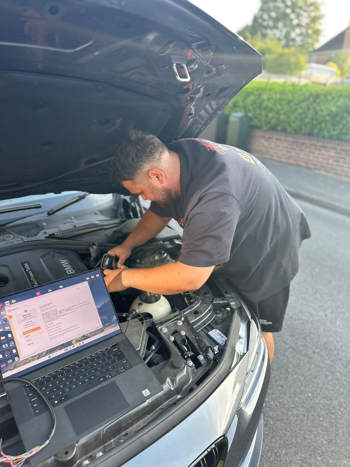 ECU remap in progress on a BMW with AutoTuner and battery support